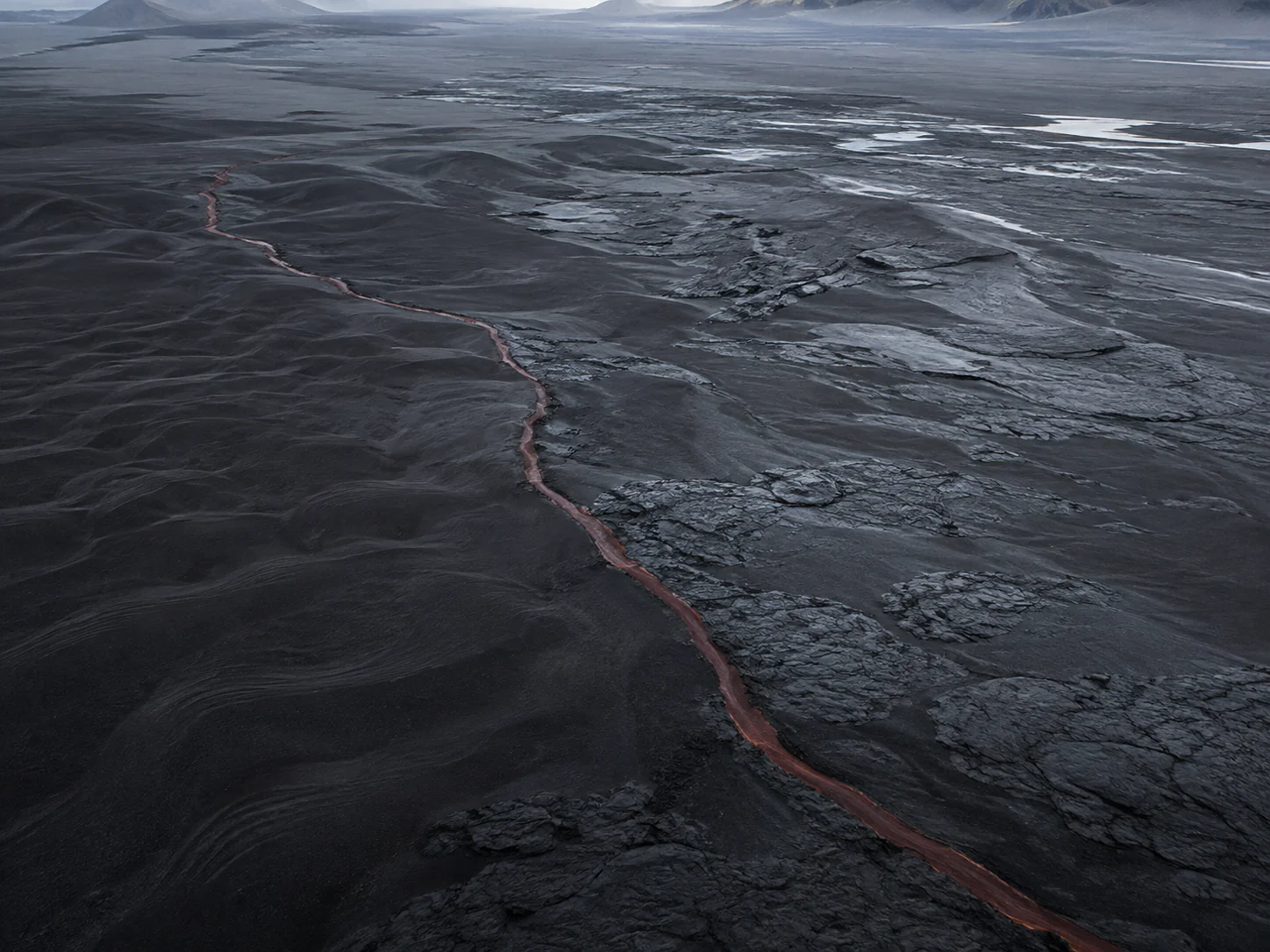 Aerial black sand red river