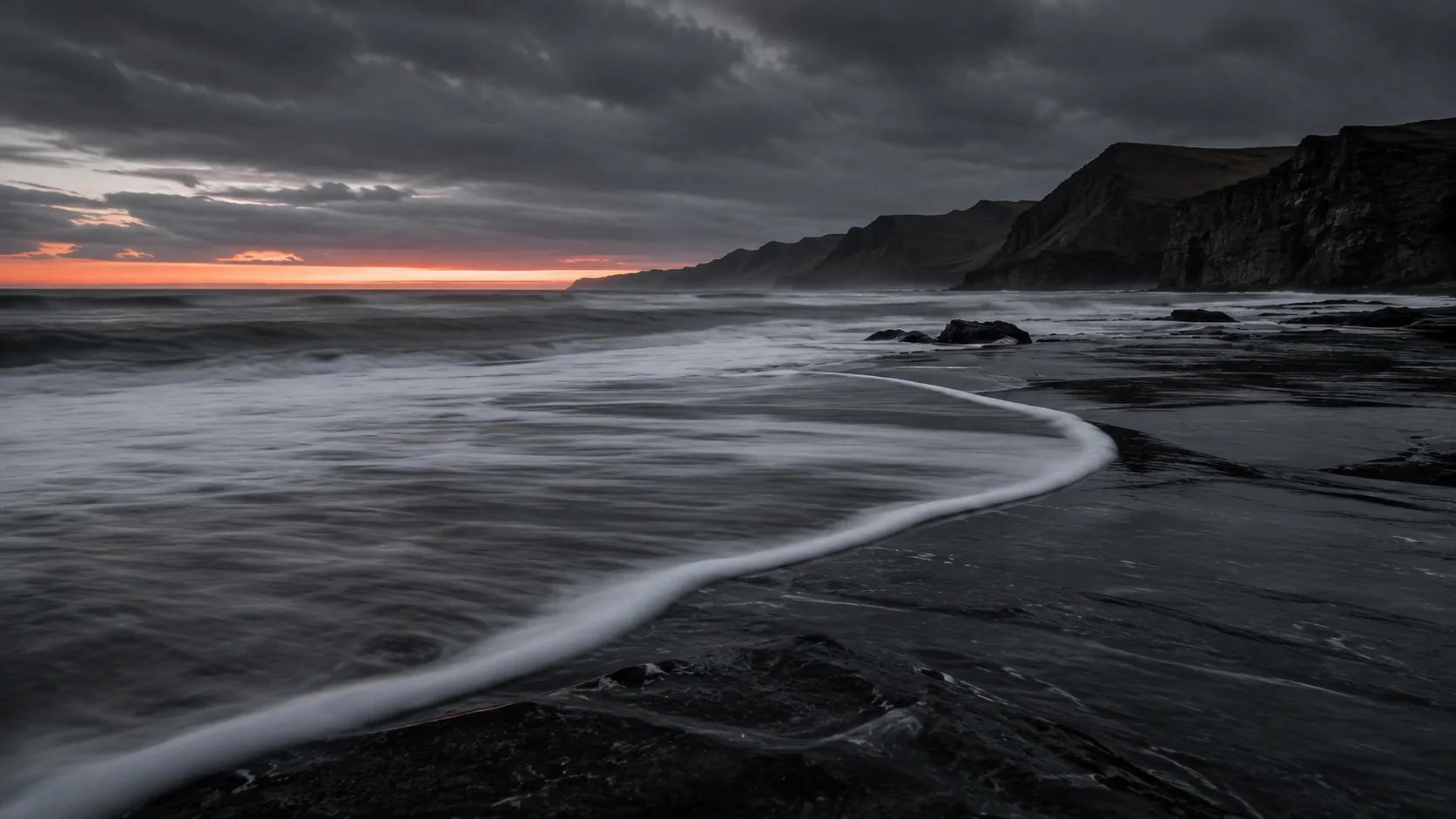 Sunset surf black sand cliffs